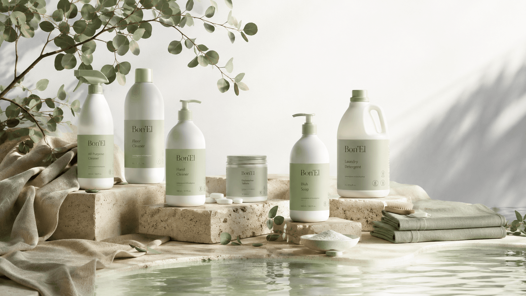 The full Bon'El range arranged on travertine beside a reflecting pool, eucalyptus overhead