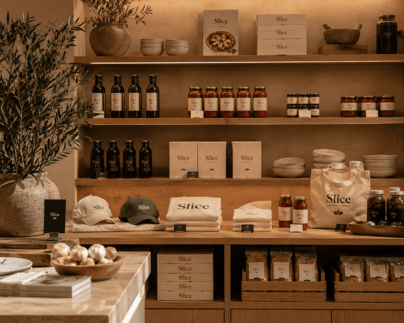 The counter inside Slice with shelves of tinned tomatoes and flour